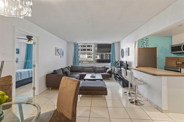 tiled living room with ceiling fan