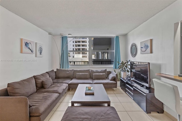 living room featuring light tile patterned flooring and a textured ceiling