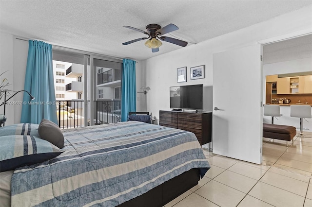 bedroom with light tile patterned floors, access to outside, a textured ceiling, and ceiling fan