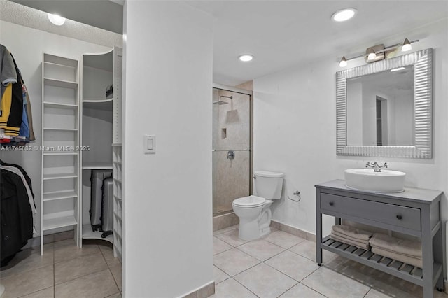 bathroom featuring vanity, toilet, an enclosed shower, and tile patterned flooring