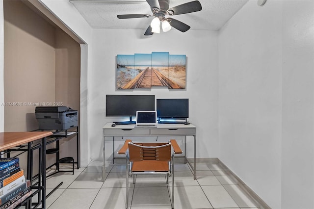 home office with ceiling fan, light tile patterned floors, and a textured ceiling