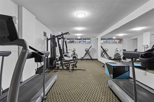 exercise room featuring a textured ceiling