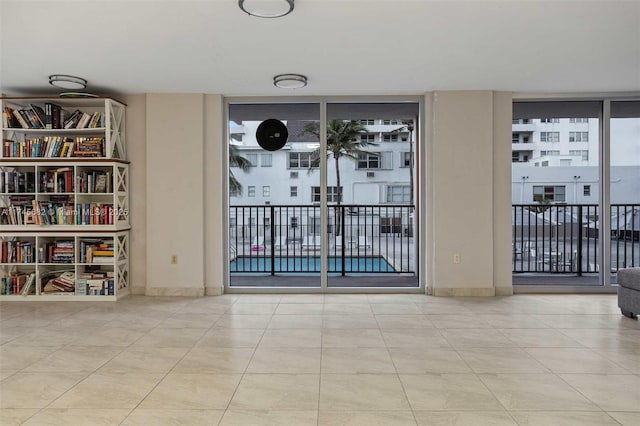 tiled empty room with floor to ceiling windows