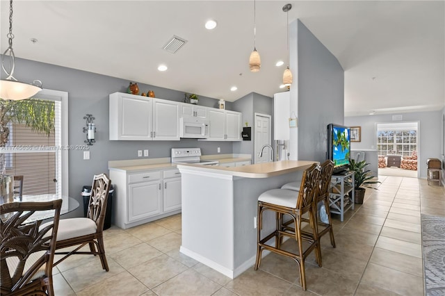 kitchen featuring white cabinetry, pendant lighting, white appliances, and light tile patterned floors