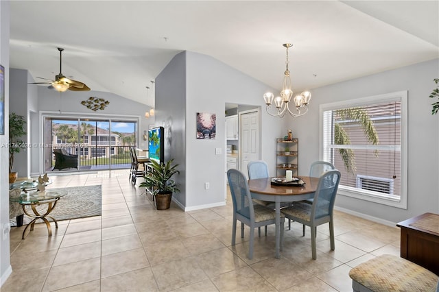 dining room featuring ceiling fan with notable chandelier, light tile patterned floors, vaulted ceiling, and a wealth of natural light