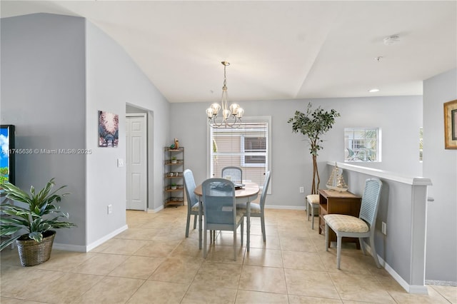 tiled dining area with an inviting chandelier, vaulted ceiling, and a wealth of natural light