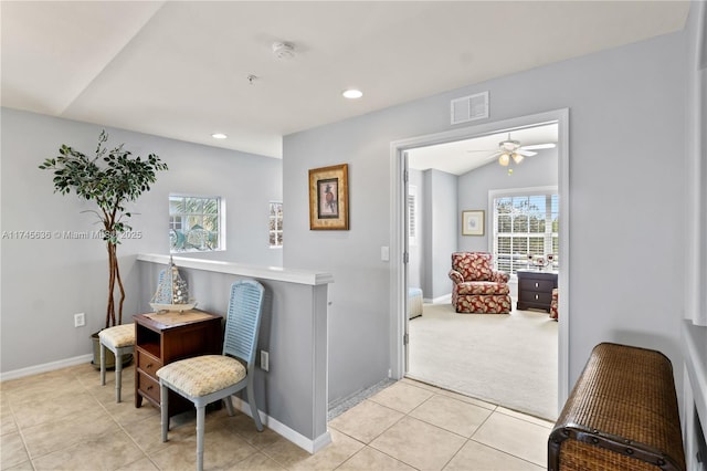 sitting room with vaulted ceiling and light tile patterned floors