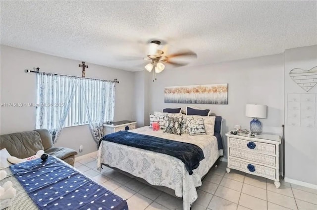 bedroom featuring a textured ceiling, baseboards, a ceiling fan, and light tile patterned flooring