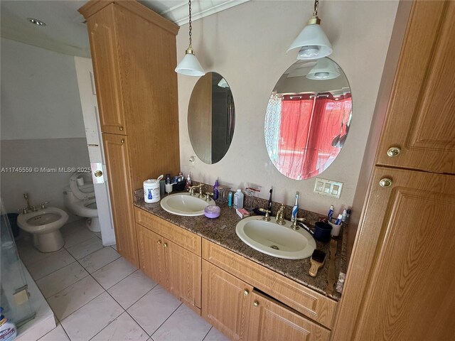 bathroom featuring a bidet, tile patterned floors, toilet, and vanity