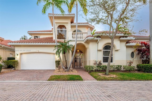 mediterranean / spanish house with a balcony and a garage