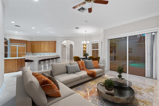 living room featuring ornamental molding and ceiling fan with notable chandelier