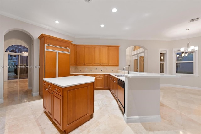 kitchen with pendant lighting, stainless steel dishwasher, a center island, and a chandelier