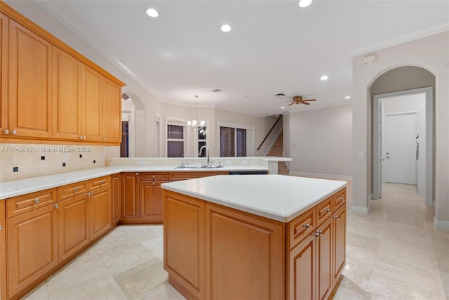 kitchen with sink, a center island, hanging light fixtures, kitchen peninsula, and decorative backsplash