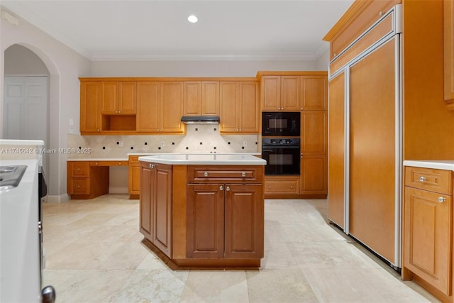 kitchen featuring tasteful backsplash, ornamental molding, a center island, and black appliances