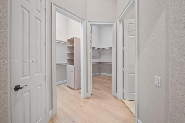 hallway with light hardwood / wood-style flooring