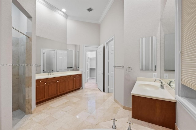 bathroom with vanity, crown molding, a shower, and a towering ceiling