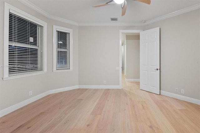 empty room with ceiling fan, ornamental molding, and light hardwood / wood-style flooring