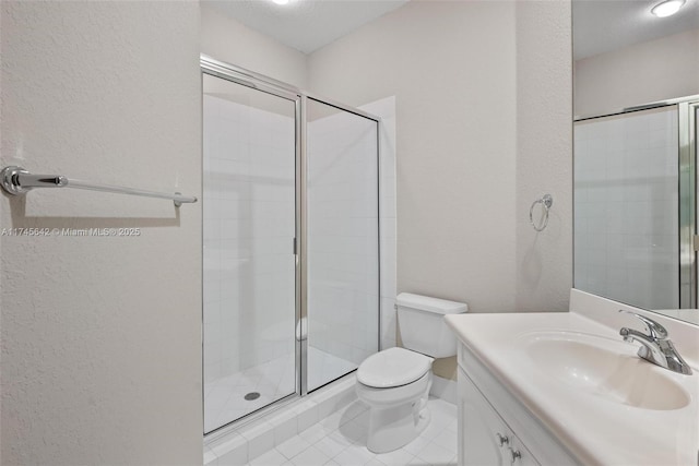 bathroom featuring vanity, toilet, tile patterned floors, and a shower with shower door