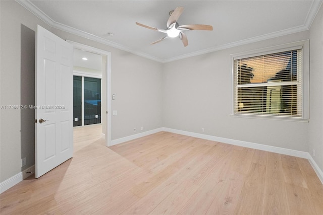 empty room featuring ornamental molding, ceiling fan, and light wood-type flooring