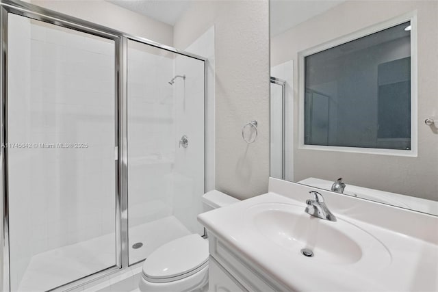 bathroom featuring vanity, toilet, and walk in shower