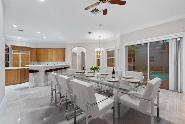 dining room with crown molding and ceiling fan with notable chandelier