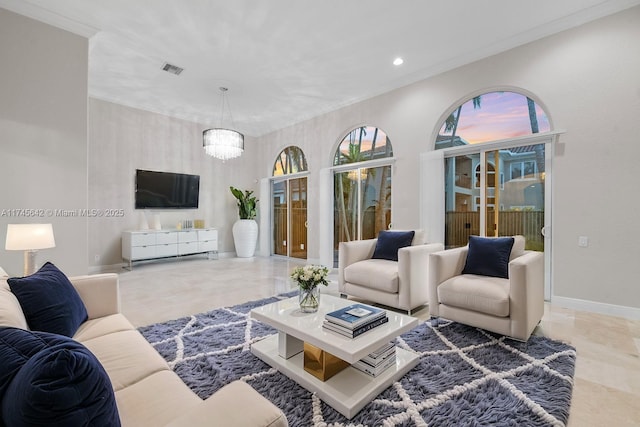 living room with ornamental molding and a chandelier