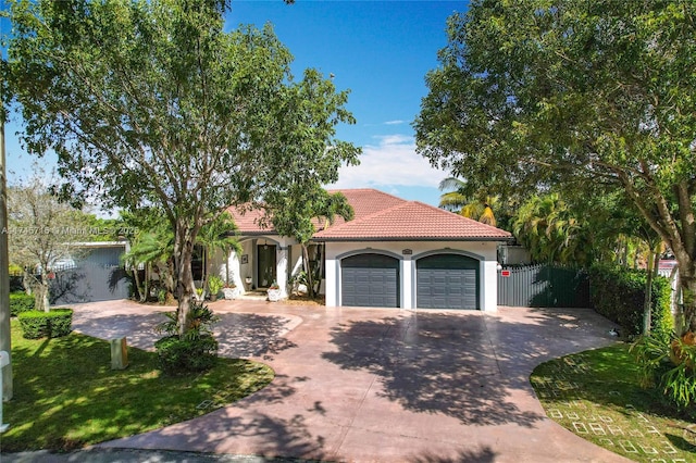 mediterranean / spanish-style house with a garage