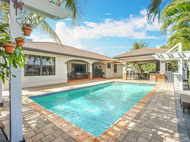 view of pool featuring a patio, an outdoor bar, and a pergola