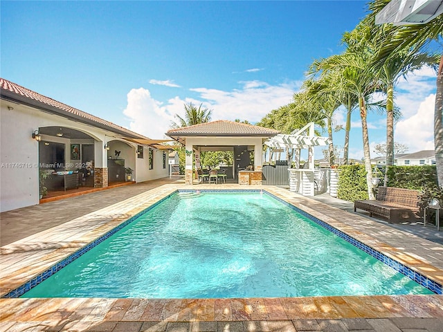 view of swimming pool with a pergola and a patio