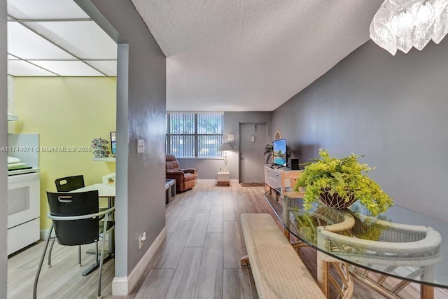 hallway with hardwood / wood-style floors and a textured ceiling