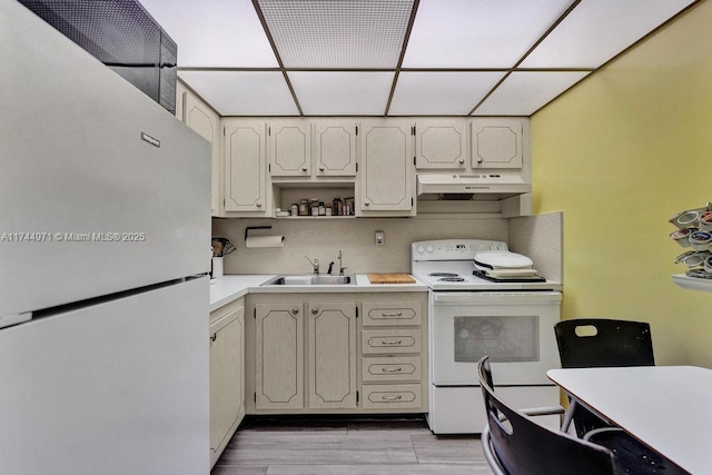 kitchen featuring white cabinetry, sink, white appliances, and light hardwood / wood-style flooring