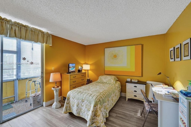 bedroom with hardwood / wood-style flooring and a textured ceiling