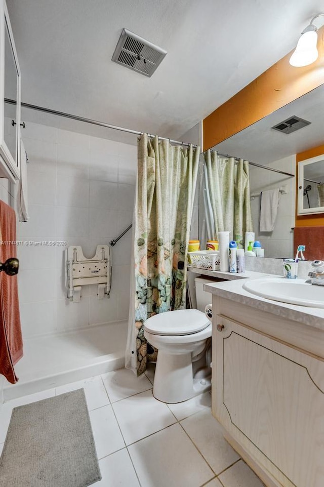 bathroom with tile patterned flooring, vanity, a shower with shower curtain, and toilet