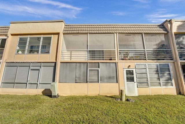 view of side of home with a lawn