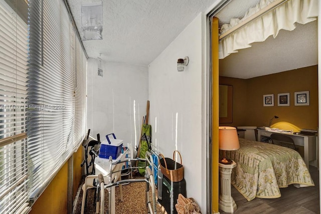 bedroom featuring wood-type flooring and a textured ceiling