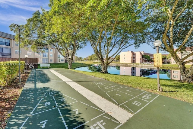 surrounding community featuring a yard and a water view