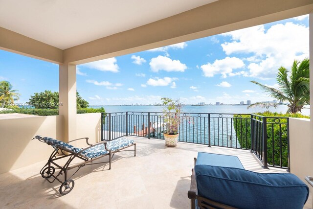 view of patio / terrace featuring a water view and a balcony