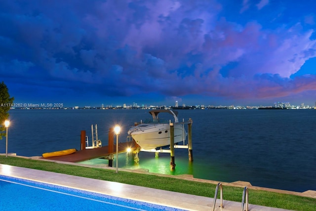dock area featuring boat lift and a water view
