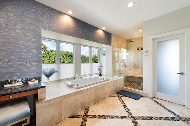 bathroom with a garden tub, recessed lighting, and tiled shower