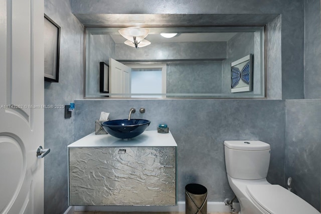 half bathroom with vanity and toilet