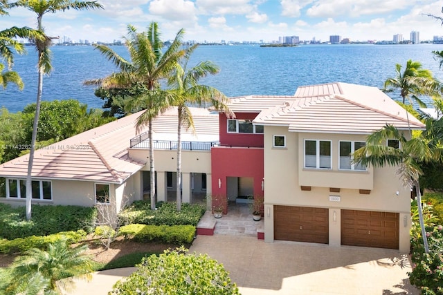 1500 NE 103rd St, Miami Shores, FL 33138 - view of front of property with a balcony, an attached garage, and a water view