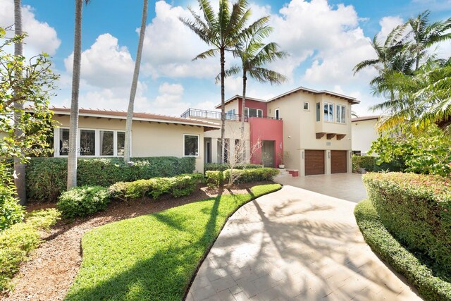 1500 NE 103rd St, Miami Shores, FL 33138 - mediterranean / spanish home with stucco siding, an attached garage, concrete driveway, and a balcony