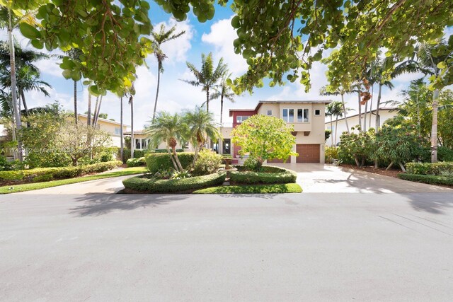 mediterranean / spanish house with concrete driveway, an attached garage, and stucco siding