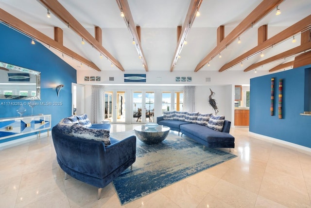 tiled living room featuring baseboards, rail lighting, and beam ceiling