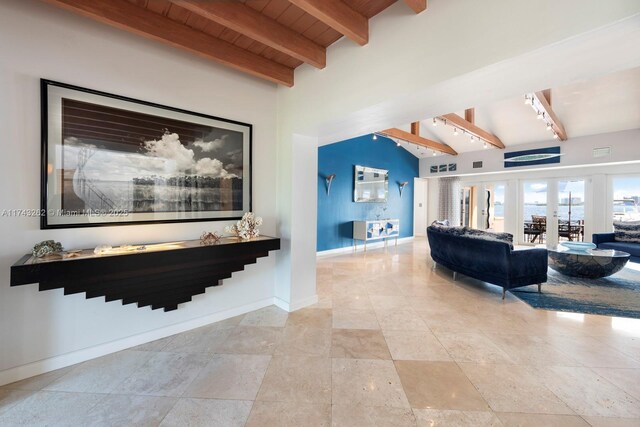 interior space with visible vents, baseboards, vaulted ceiling with beams, wood ceiling, and french doors