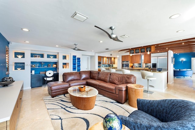 living area featuring recessed lighting and visible vents