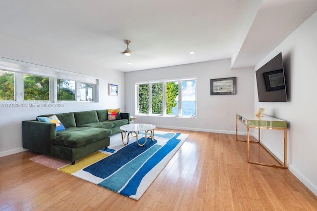 living room with recessed lighting, baseboards, and wood finished floors