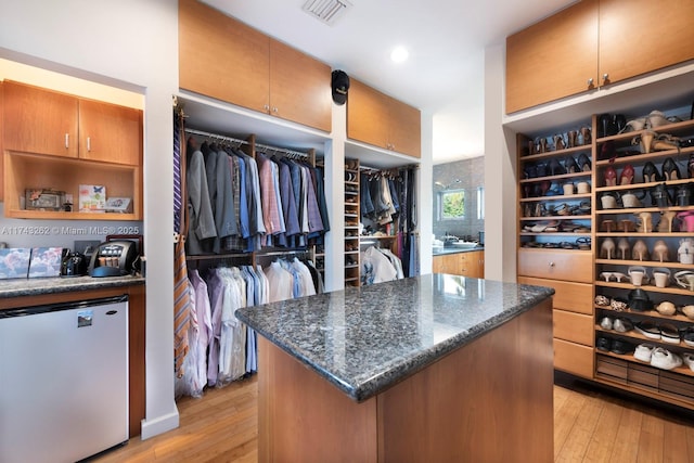 walk in closet featuring light wood-style flooring and visible vents