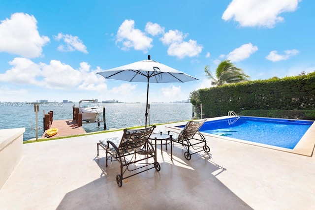 pool featuring a patio, a boat dock, and a water view