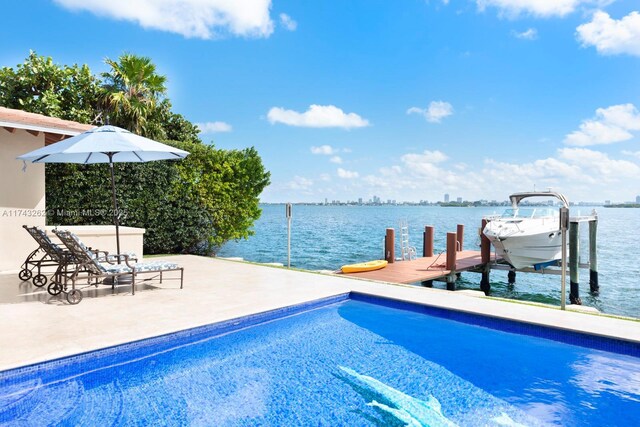 1500 NE 103rd St, Miami Shores, FL 33138 - outdoor pool with a boat dock, a water view, boat lift, and a patio area